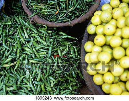 Stock Image - Chilies And Lemons For Sale In The Market. Fotosearch