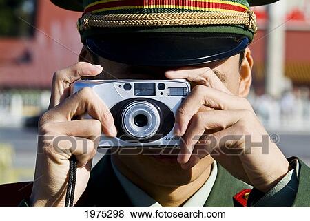 Stock Photo - China, Beijing, A Peoples Republic Of China Guard Take A Picture Of Tiananmen Square.. Fotosearch