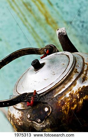 Stock Image - China, Beijing, Old And Worn Tea Kettle.. Fotosearch