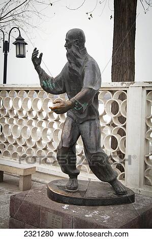 Stock Image - China, Beijing, Statue of man doing Tai Chi. Fotosearch