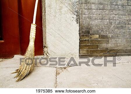 Stock Photography - China, Broom Leaning Against Cement Wall; Beijing. Fotosearch