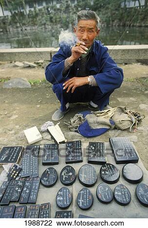 China, Canton, Chinese Vendor Selling Calligraphy Stones, Squatting And Smoking No Model Release View Large Photo Image Stock Image - China, Canton, Chinese Vendor Selling Calligraphy Stones, Squatting And Smoking No Model Release. Fotosearch