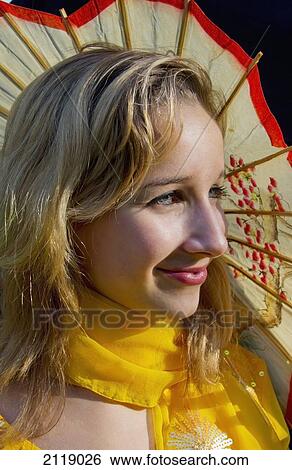 Stock Photograph - China, Girl with yellow parasol; Hong Kong. Fotosearch
