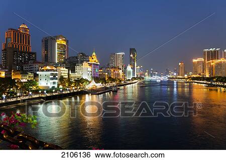 Stock Photograph - China, Guangdong, Waterfront at dusk; Guangzhou. Fotosearch