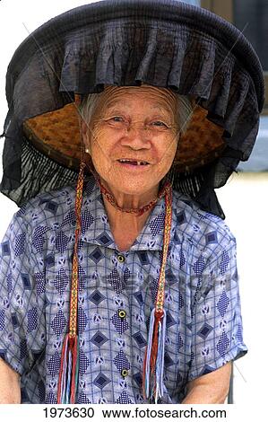 Stock Image - China, Hong Kong, Local Senior Woman Weaing A Traditional Black Hat.. Fotosearch