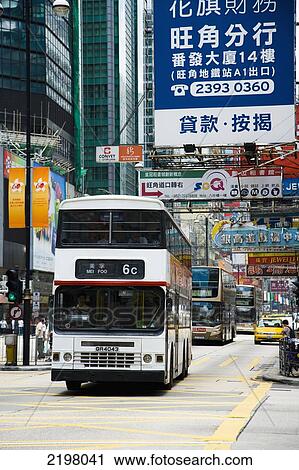 Stock Image - China, Hong Kong, Streets bustle with taxis and busses; Kowloon. Fotosearch