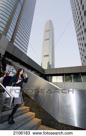 Stock Image - China, People walking on steps in central district; Hong Kong. Fotosearch