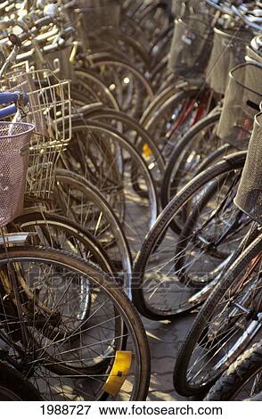 Stock Photo - China, Shanghai, Bicycle Parking Lot, Many Wheels Face Each Other. Fotosearch
