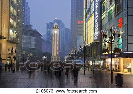 Stock Image - China, Sichuan, Pedestrian traffic near Victory Monument; Chongqing. Fotosearch