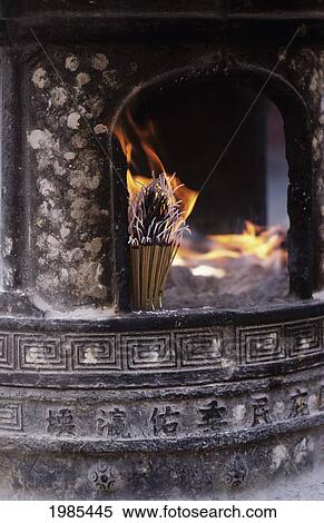 Stock Photography - China, Tianjin, Fireplace with burning incense sticks; Culture street. Fotosearch
