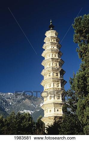 Stock Image - China, View of pagoda with mountain in background; Dali. Fotosearch