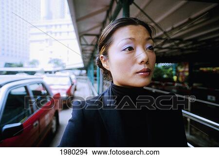 China, Woman waiting for taxi; Hong Kong View Large Photo Image Picture - China, Woman waiting for taxi; Hong Kong. Fotosearch