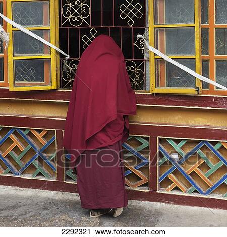 Stock Image - China, Xizang, Lhasa, Drepung Monastery, Woman in traditional outfit. Fotosearch