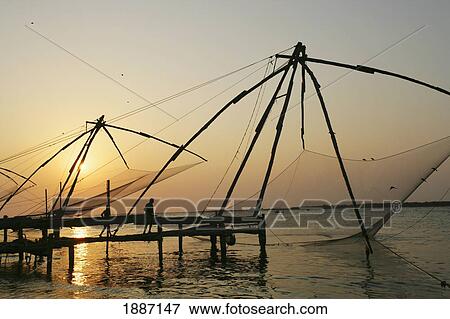 Chinese Fishing Nets Hanging In The Water At Sunset, Fort Kochi. View Large Photo Image Stock Photo - Chinese Fishing Nets Hanging In The Water At Sunset, Fort Kochi.. Fotosearch