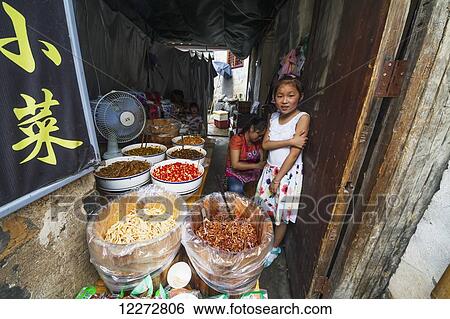 Chinese girl in a food shop, Hongcun, Anhui, China View Large Photo Image Stock Photograph - Chinese girl in a food shop, Hongcun, Anhui, China. Fotosearch