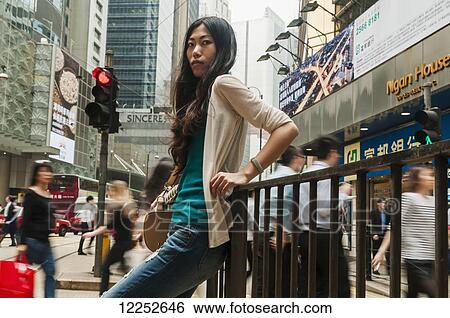 Chinese young woman in a busy, urban centre; Hong Kong, China View Large Photo Image Stock Photograph - Chinese young woman in a busy, urban centre; Hong Kong, China. Fotosearch
