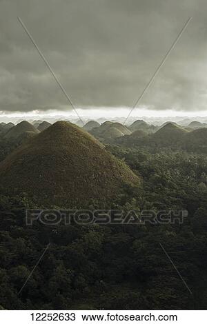 Chocolate hills landscape from Bohol Island, a big storm covers the sky making an interesting lighting effect; Carmen, Bohol Island, Philippines View Large Photo Image Stock Image - Chocolate hills landscape from Bohol Island, a big storm covers the sky making an interesting lighting effect; Carmen, Bohol Island, Philippines. Fotosearch