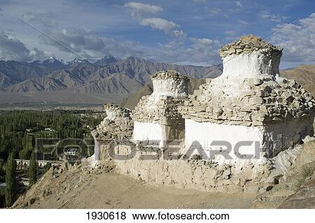 Stock Photo - Chortens on a hill overlooking the Indus Valley and Leh. Leh was the capital of the Himalayan kingdom of Ladakh, now the Leh District in the state of Jammu and Kashmir, India. Leh is at an altitude of 3, 500 meters (11, 483 ft).. Fotosearch