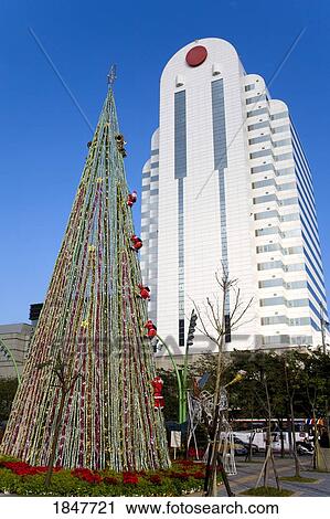 Stock Image - Christmas Tree & We Are Family Tower On Xinyi Road; Taipei, Taiwan, Republic Of China. Fotosearch