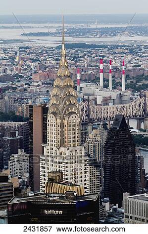Stock Photo - Chrysler Building amidst skyscrapers at dusk, as seen from the Empire State Building, New York City, New York, United States. Fotosearch