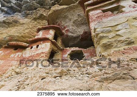 Chullpas (stone tomb chambers) of the Chachapoya culture with walls colored with red figures, nestled in the limestone cliffs of Cerro Carb View Large Photo Image Stock Photography - Chullpas (stone tomb chambers) of the Chachapoya culture with walls colored with red figures, nestled in the limestone cliffs of Cerro Carb. Fotosearch