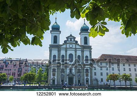 Stock Image - Church along River Reuss; Lucerne, Switzerland. Fotosearch