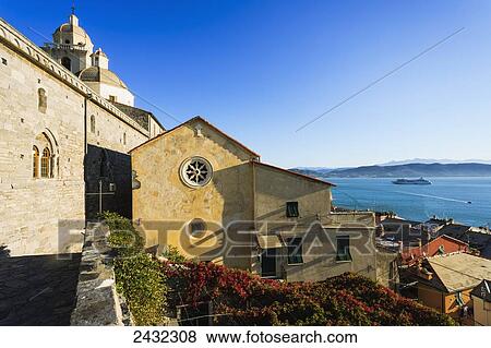 Stock Photo - Church and residential buildings along the coast of the Italian Riviera; Porto Venere, Liguria, Italy. Fotosearch