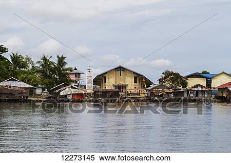 Stock Photography - Church and stilt houses in Kampung Ayapo, Lake Sentani, Papua, Indonesia. Fotosearch