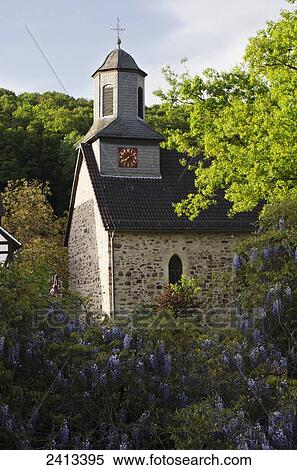 Stock Photography - Church at Niederkaufungen with climbing Wisteria; Kassel district, Germany. Fotosearch