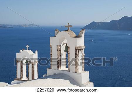 Stock Image - Church bell towers overlooking the caldera; Oia, Santorini, Cyclades, Greek Islands, Greece. Fotosearch