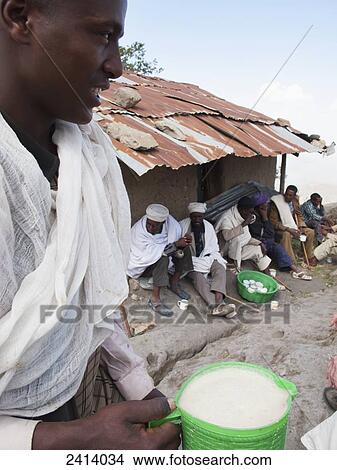 Picture - Church men drinking local tella beer at Easter, Asheten Maryam church; Lalibela, Asmara region, Ethiopia. Fotosearch