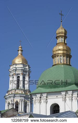 Stock Photo - Church of the Raising of the Cross, entrance to the lower cave complex at the Pecherska Lavra where pilgrims pray at the glass coffins of mummified monks, plus Great Bell Tower beyond; Kiev, Ukraine. Fotosearch
