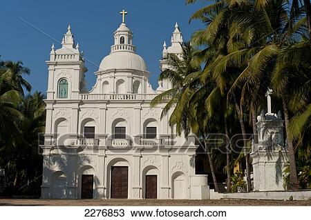 Stock Image - Church surrounded by palm trees; Goa, India. Fotosearch