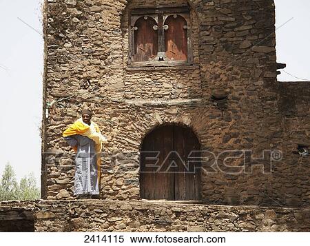 Stock Photography - Churchman at gateway, Debre Birhan Selassie church; Gondar, Amhara region, Ethiopia. Fotosearch