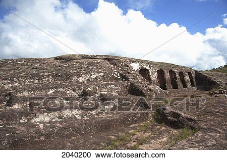 Stock Image - Cinco Hornacinas (Five Niches) On The Carved Stone Hill Of El Fuerte De Samaipata, Santa Cruz Department, Bolivia. Fotosearch