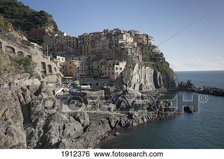 Stock Photograph - Cinque Terre And Houses Along The Coast; Manarola, Liguria, Italy. Fotosearch