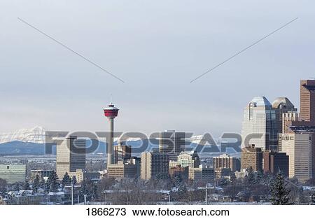 Stock Image - City Skyline With Mountain Backdrop, Calgary, Alberta, Canada. Fotosearch