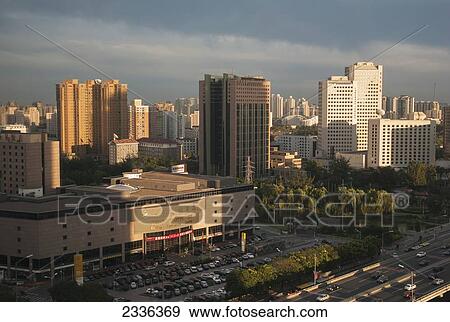 Stock Photo - Cityscape Of Buildings, A Road And A Parking Lot; Beijing, China. Fotosearch