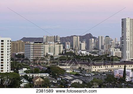 Stock Photo - Cityscape of Honolulu and Diamond Head at sunset; Honolulu, Oahu, Hawaii, United States of America. Fotosearch