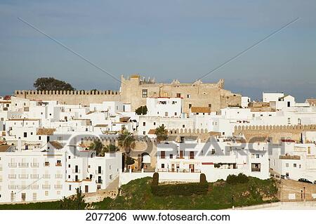 Stock Photograph - Cityscape Of White And Brown Buildings Against A Blue Sky; Vejer De La Frontera Andalusia Spain. Fotosearch