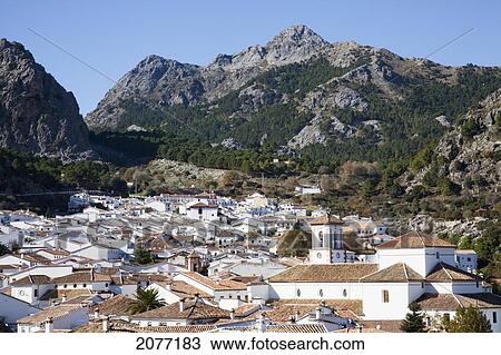 Cityscape Of White Buildings With Mountains In The Distance Against A Blue Sky; Grazalema Andalusia Spain View Large Photo Image Stock Image - Cityscape Of White Buildings With Mountains In The Distance Against A Blue Sky; Grazalema Andalusia Spain. Fotosearch