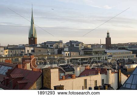 Stock Image - Cityscape With Church Spire At Sunset. Fotosearch
