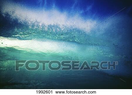 Stock Image - Clear Blue Wave Curling Over, View From Front Of Wave With Whitewash Closeup. Fotosearch