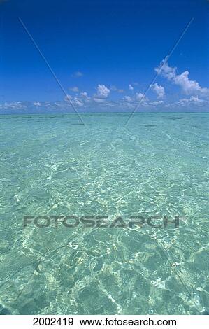 Clear Turquoise Ocean Water, Blue Sky, White Clouds, Sunlight Reflections View Large Photo Image Stock Photo - Clear Turquoise Ocean Water, Blue Sky, White Clouds, Sunlight Reflections. Fotosearch