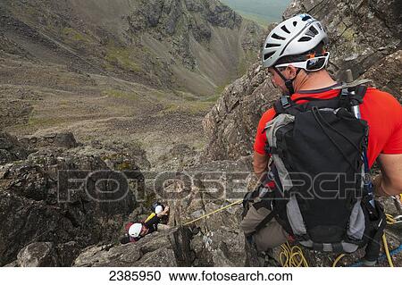 Climbers ascending Am Basteir in the Black Cuillin; Isle of Skye, Scotland View Large Photo Image Stock Image - Climbers ascending Am Basteir in the Black Cuillin; Isle of Skye, Scotland. Fotosearch