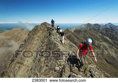 Stock Image - Climbers going up ridge near Sgurr a Mhadaidh in the Black Cuillin; Isle of Skye, Scotland. Fotosearch