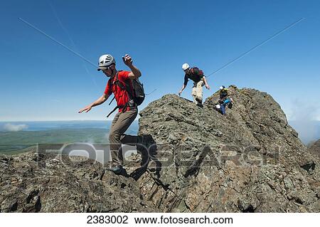 Stock Image - Climbers going up ridge near Sgurr a Mhadaidh in the Black Cuillin; Isle of Skye, Scotland. Fotosearch