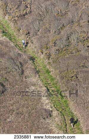 Stock Image - Climbing Steep Stairs; Pembrokeshire Coast Path, Wales, United Kingdom. Fotosearch