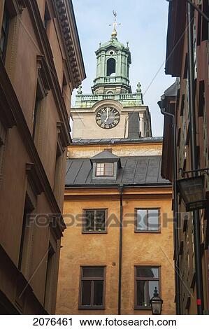 Clock Tower On A Church Rising Above The Rooftops In Old Town; Stockholm Sweden View Large Photo Image Stock Image - Clock Tower On A Church Rising Above The Rooftops In Old Town; Stockholm Sweden. Fotosearch