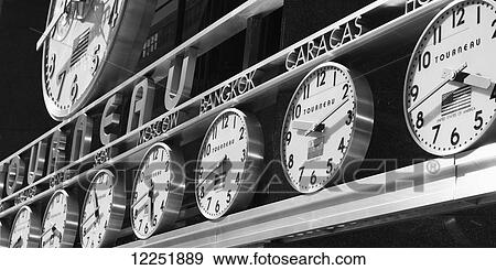 Clocks with times from around the world in a row; New York City, New York, United States of America View Large Photo Image Stock Photo - Clocks with times from around the world in a row; New York City, New York, United States of America. Fotosearch